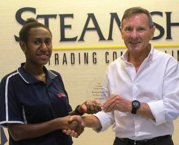 Man and woman jointly holding up an award made of clear material